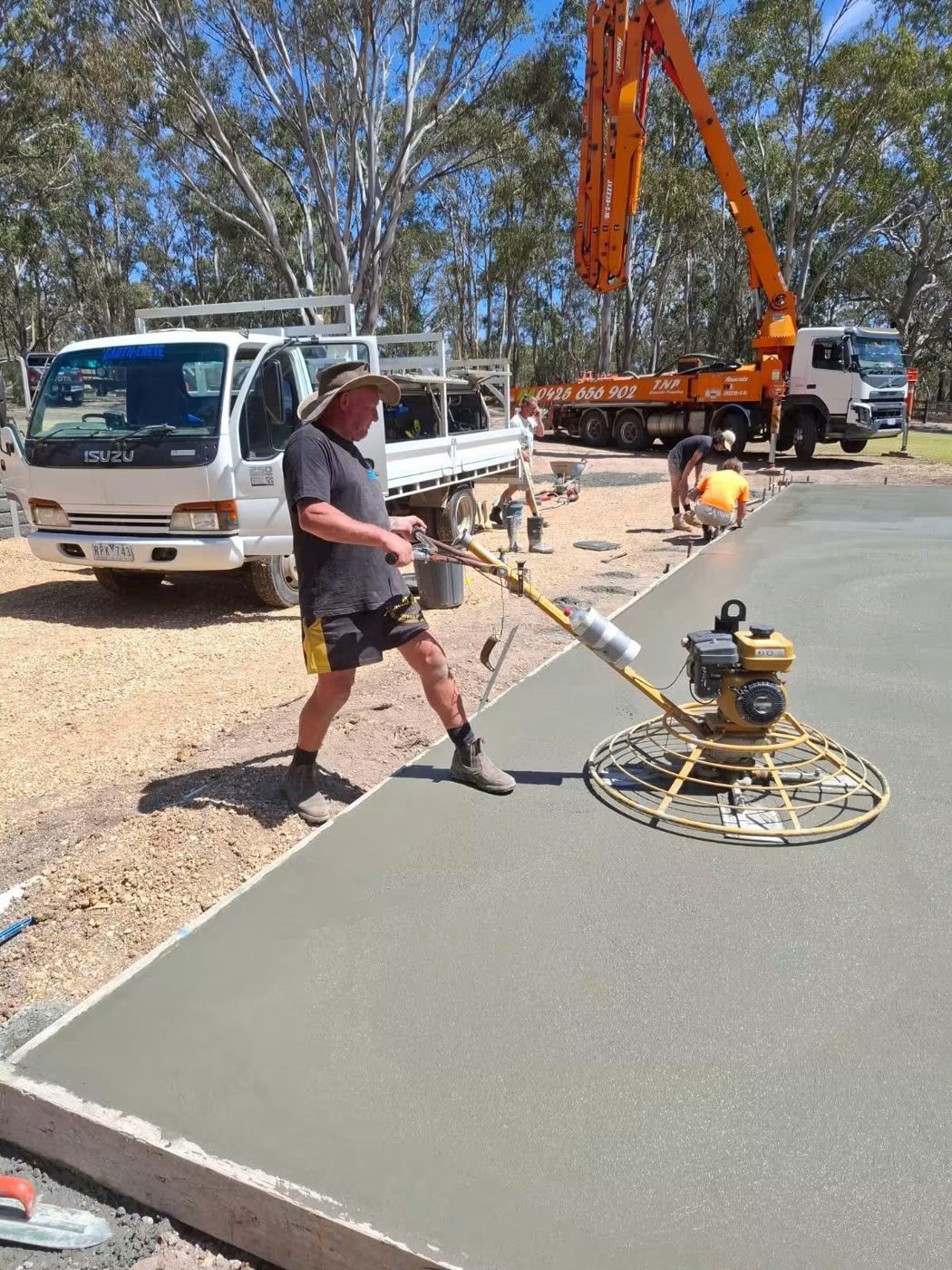 Mitch and the Earth-Crete crew finishing a concrete slab on site
